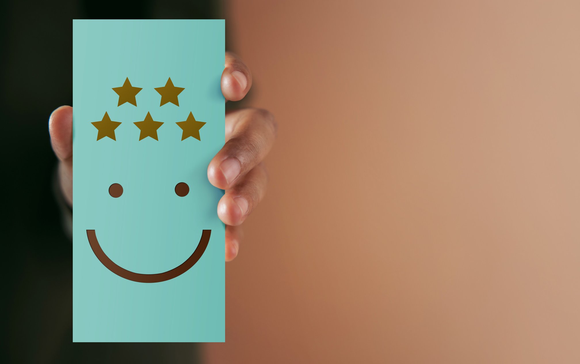 Customer Holding a Five Star Survey with Smiley